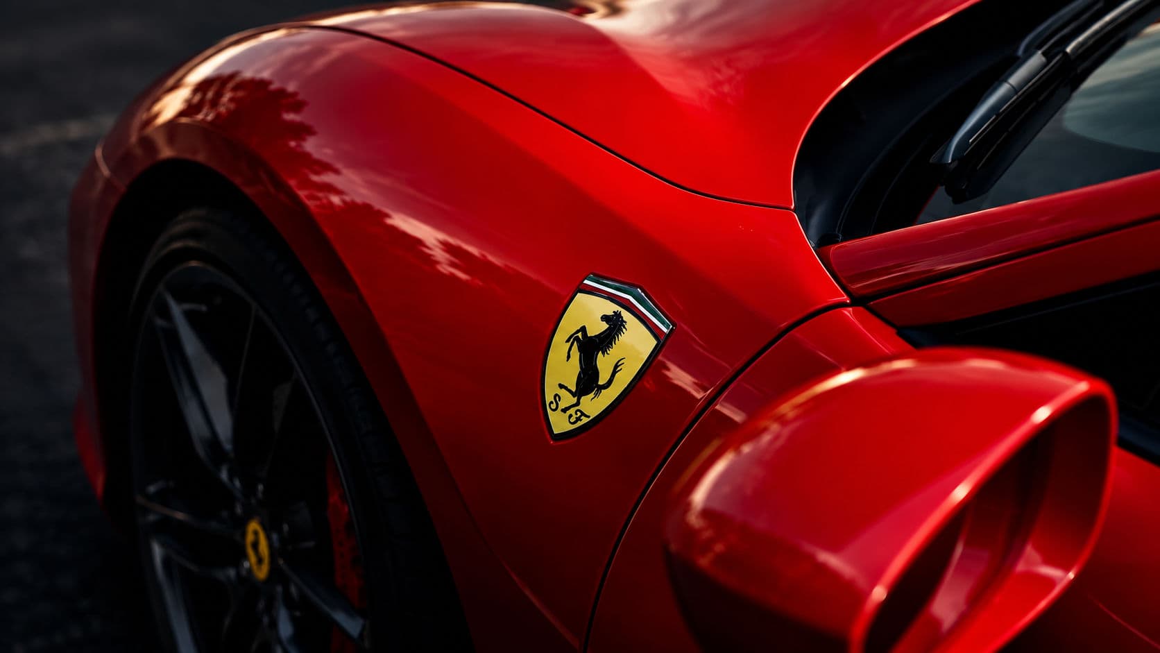 488 GTB: Close-up of the Ferrari badge on the red body of a Ferrari 488 GTB — RC24.