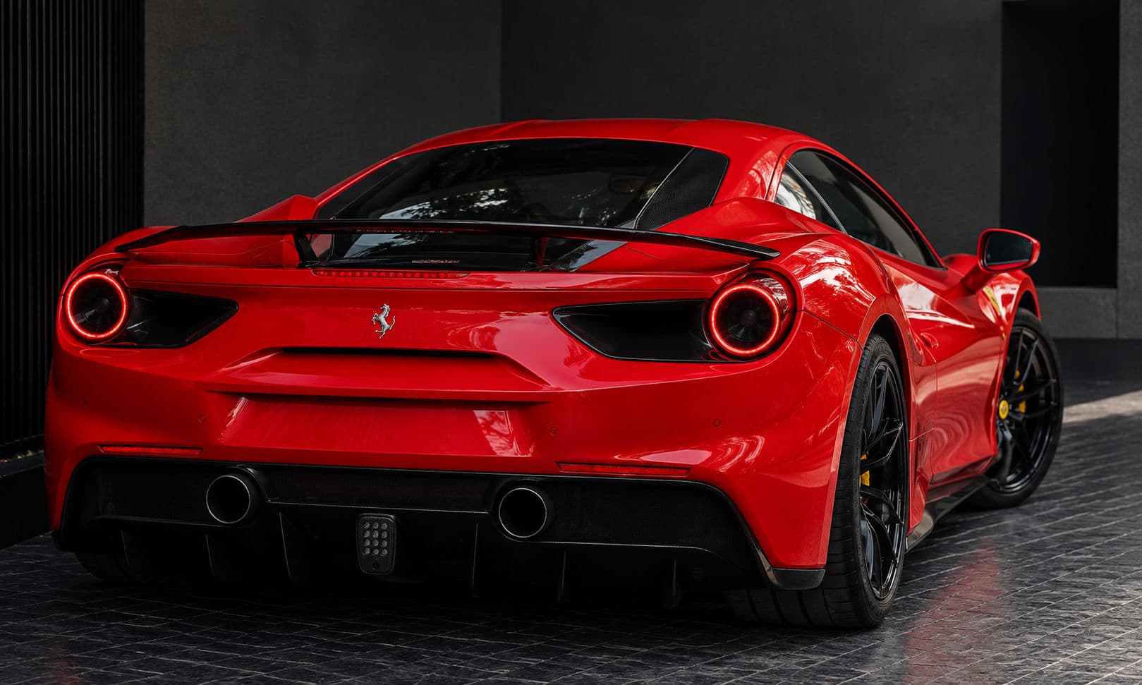 488 GTB: Red Ferrari 488 GTB, rear three-quarter view with black spoiler — RC24.