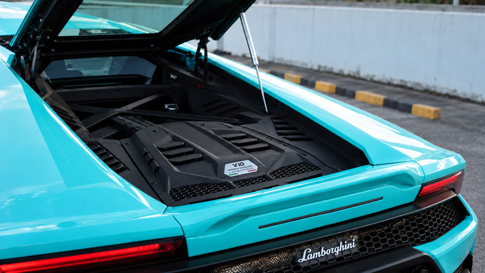 Huracan EVO RWD: Lamborghini Huracan EVO RWD 2024 in Electric Aqua, rear engine bay open with V10 engine visible