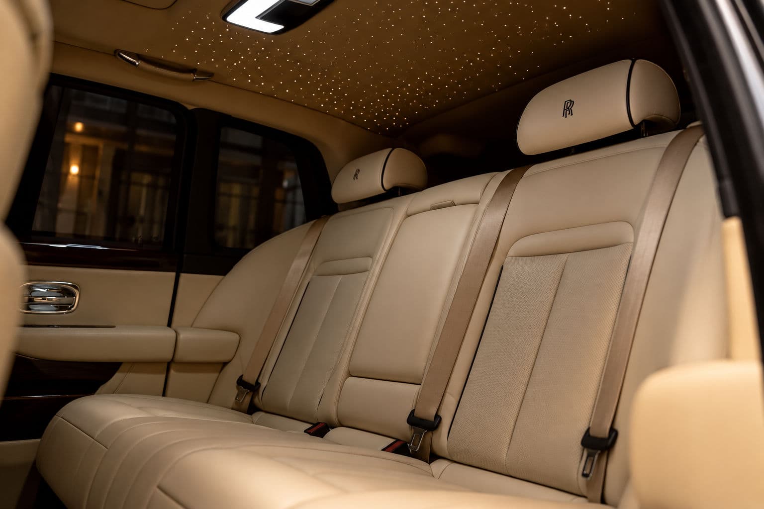 Cullinan: Rolls-Royce Cullinan 2024 rear passenger seats in beige leather with illuminated Starlight headliner — RC24